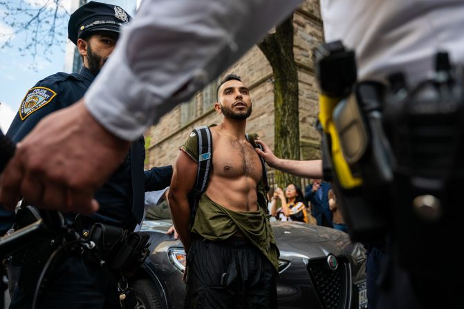 A man is detained after a scuffle as pro-Palestinian protesters rally outside Fordham on May 1.