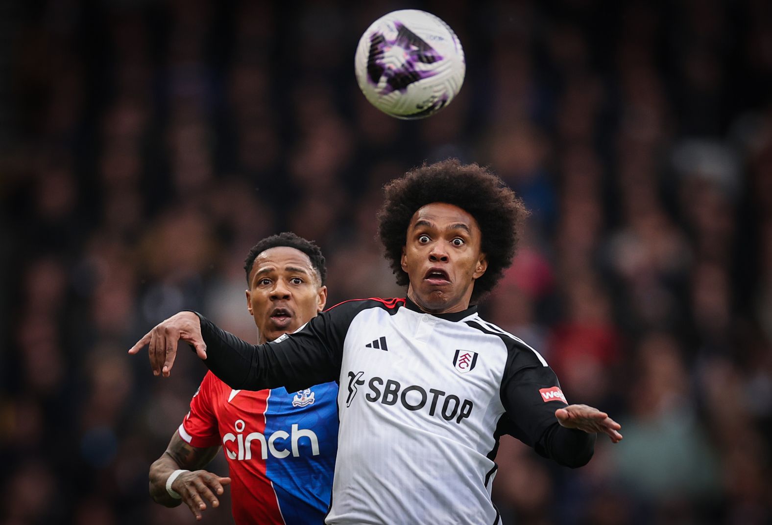Fulham's Willian, right, is pressured by Crystal Palace's Nathaniel Clyne as he chases a loose ball during a Premier League match in London on Saturday, April 27.