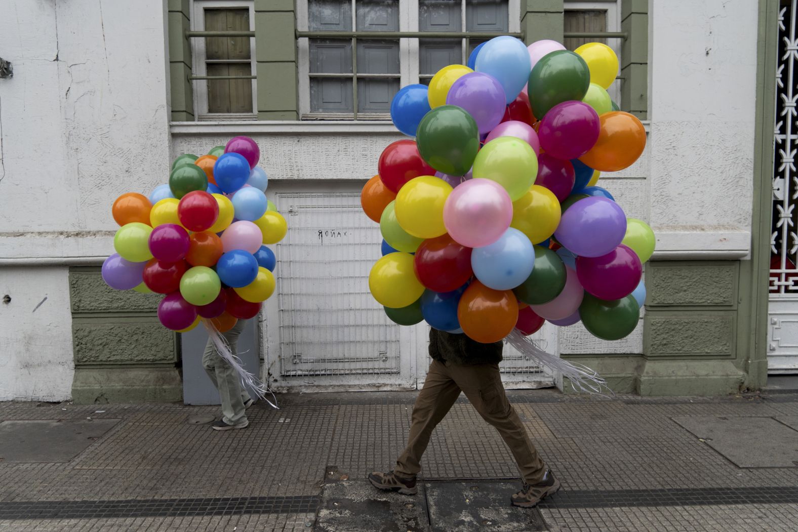 Protesters carry balloons to an International Workers' Day march in Santiago, Chile, on Wednesday, May 1.