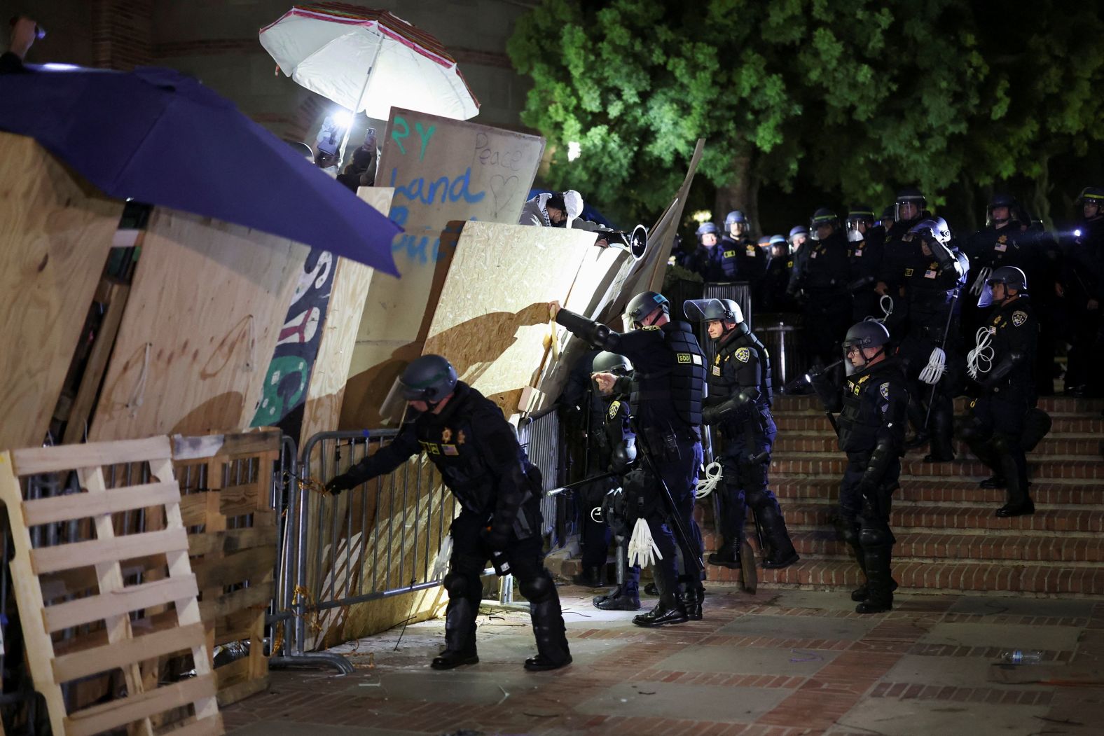 Police take down a barricade as protesters gather at an encampment at UCLA on May 2.