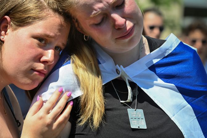 Emma, right, sheds a tear as she and her friend Aryn listen to the names of Israeli hostages as they attend a pro-Israel rally at George Washington University on May 2.