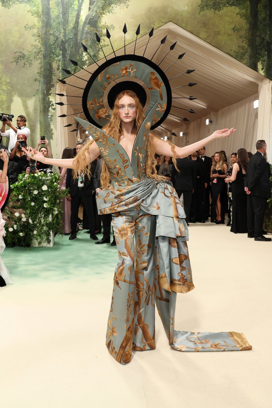 Designer Harris Reed in a theatrical creation of his own making with a radiant headpiece that looks inspired by Renaissance paintings, a twist on the golden halos of religious icons.