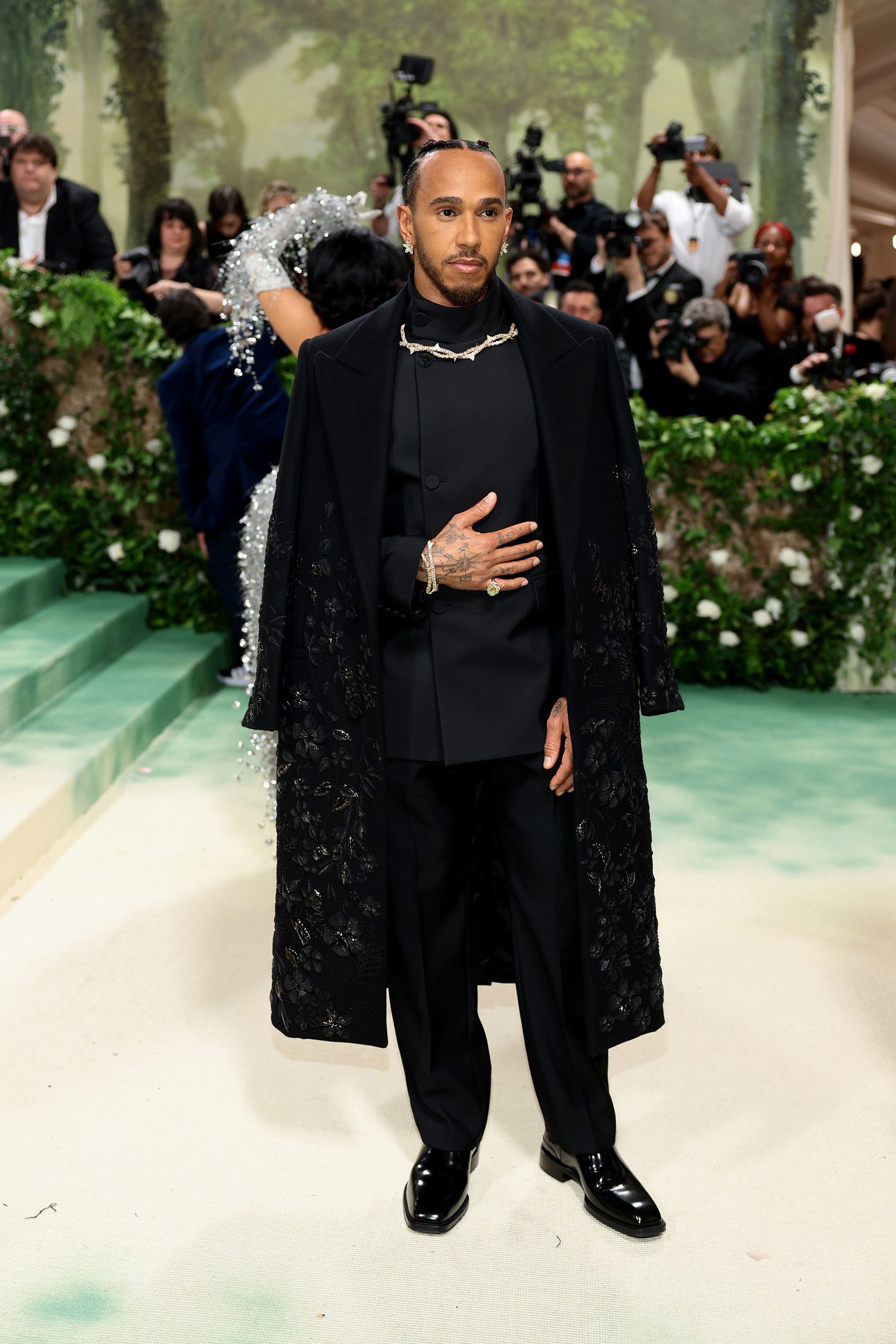 British Formula One driver Lewis Hamilton wore an oversized black coat from Burberry. The outfit was an homage to an unnamed slave who became the first Black gardener in Wales in the 18th century. 