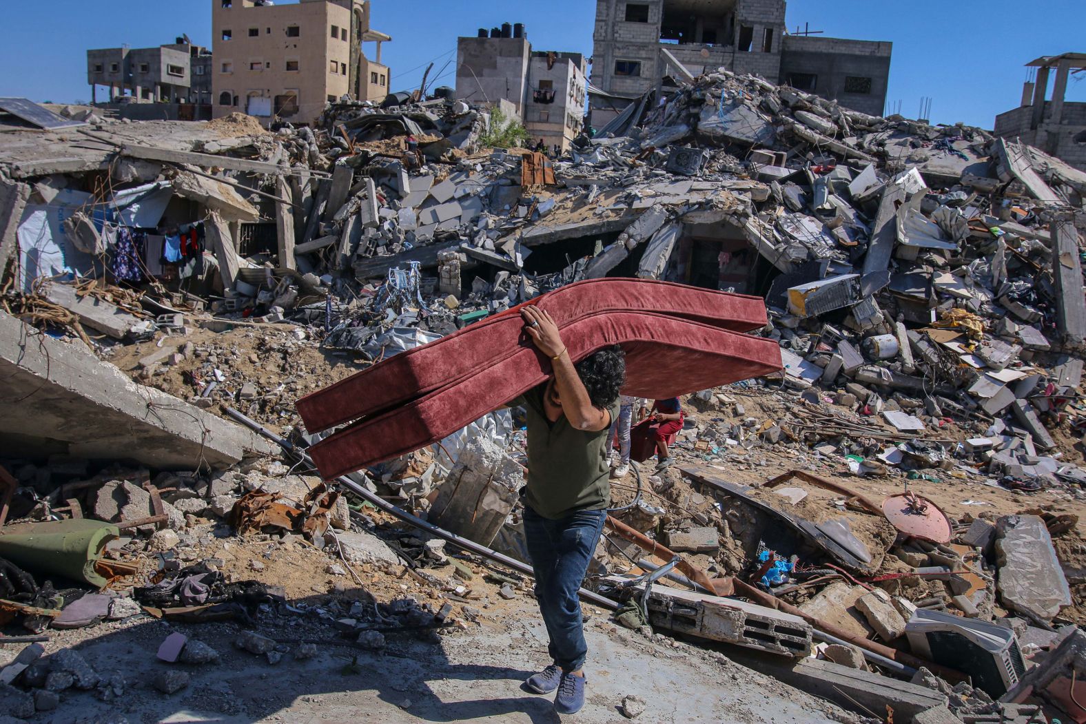 A Palestinian man, after fleeing from Rafah, Gaza, collects furnishings from the rubble of destroyed homes in Khan Younis, Gaza, on Tuesday, May 7. <a href="index.php?page=&url=https%3A%2F%2Fwww.cnn.com%2F2024%2F05%2F06%2Fmiddleeast%2Fisrael-gaza-eastern-rafah-evacuation-notice-hnk-intl%2Findex.html" target="_blank">Gazans began leaving eastern Rafah on Monday</a> after Israel's military issued a call for residents there to "evacuate immediately," raising questions over whether Israel would soon carry out its long-threatened assault on the city. During seven months of war, more than 1 million Palestinians have fled to Rafah, where Hamas is believed to have regrouped after Israel's destruction of much of the strip's north.