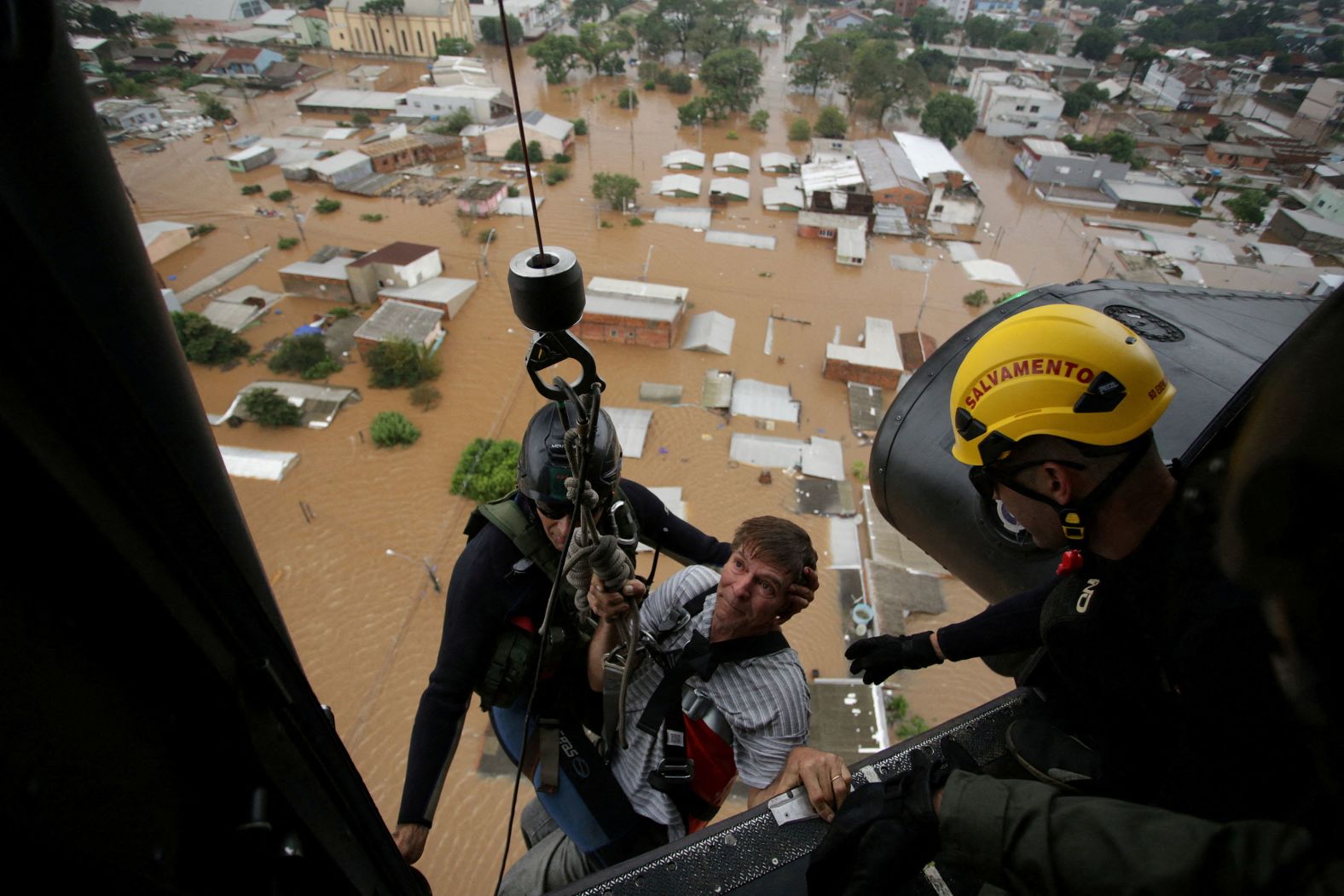 A man is rescued by military firefighters after flooding in Canoas, Brazil, on Saturday, May 4. At least 95 people have died in the<a href="index.php?page=&url=https%3A%2F%2Fwww.cnn.com%2F2024%2F05%2F08%2Fweather%2Fbrazil-flooding-satellite-imagery-intl%2Findex.html" target="_blank"> heavy rainfall and floods</a> that have torn through the state of Rio Grande do Sul, where storms have affected more than 1 million people in 385 municipalities, according to the civil defense.