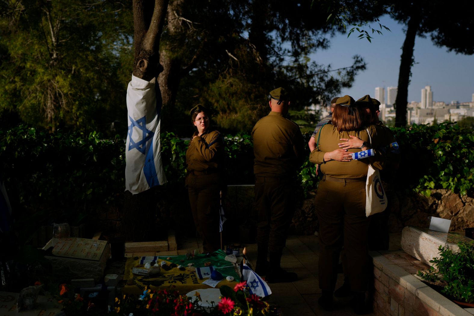 Israelis visit the graves of fallen soldiers at the Mount Herzl cemetery in Jerusalem on Thursday, May 9.