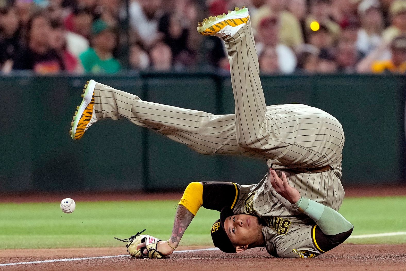 San Diego Padres third baseman Manny Machado falls while trying to field a ball during a Major League Baseball game in Phoenix on Saturday, May 4.
