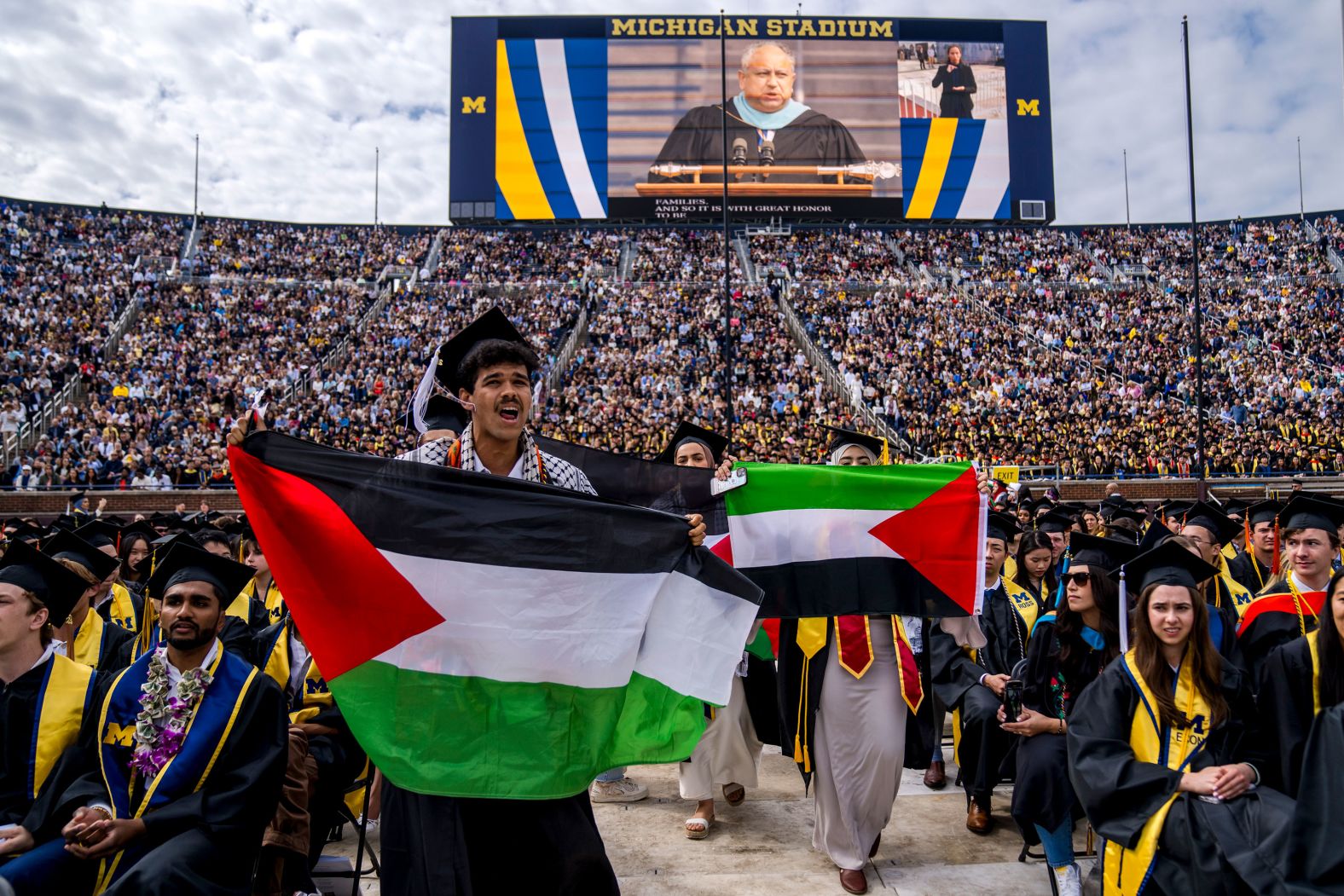 Students hold Palestinian flags during the University of Michigan's spring commencement ceremony on Saturday, May 4. <a href="index.php?page=&url=https%3A%2F%2Fwww.cnn.com%2Fbusiness%2Flive-news%2Funiversity-protests-pro-palestinian-israel-05-04-24%2Fh_e15281e5ca173beaf1a710dd5d220a88" target="_blank">Protesters were removed from the ceremony</a> after briefly interrupting the proceedings.