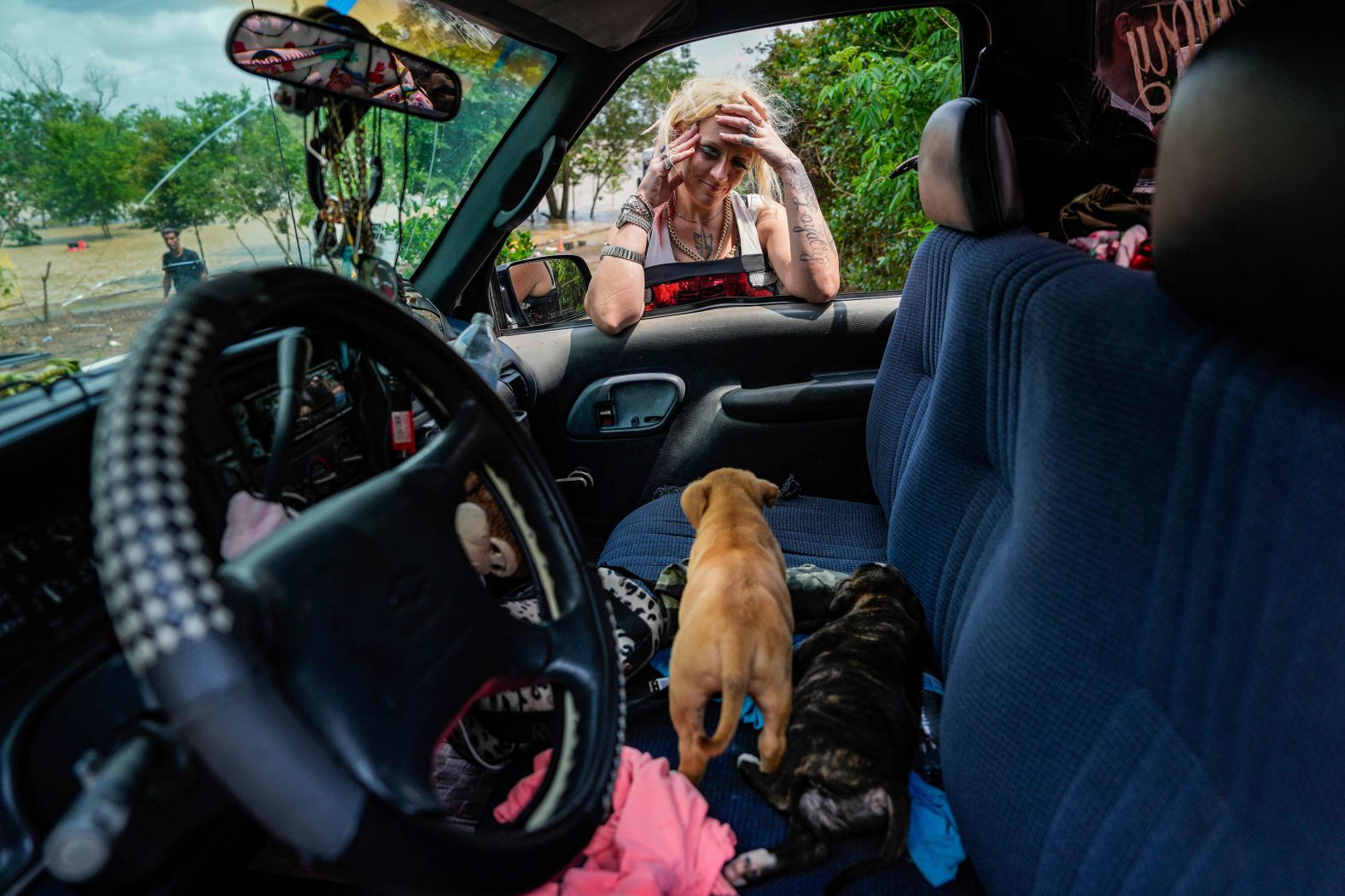 A woman checks on two of her puppies after her neighborhood was evacuated because of severe flooding in Channelview, Texas, on Saturday, May 4. <a href="index.php?page=&url=https%3A%2F%2Fwww.cnn.com%2F2024%2F05%2F05%2Fweather%2Ftexas-rivers-flooding-rain-forecast%2Findex.html" target="_blank">Days of rain caused rivers to swell</a>, leaving homes and businesses flooded and thousands of people displaced.