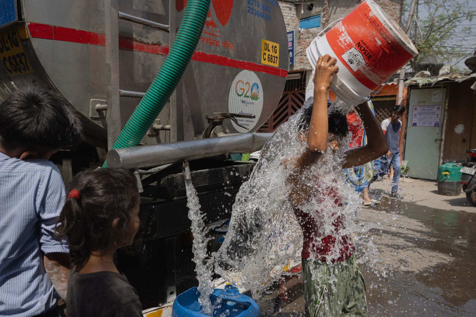 A boy cools himself with potable water from the New Delhi Municipal Council water tanker on Thursday, May 2. The hot weather has been brutal in many South Asian countries where, <a href="index.php?page=&url=https%3A%2F%2Fwww.cnn.com%2F2023%2F08%2F07%2Fasia%2Fheat-waves-children-impact-south-asia-unicef-report-intl-hnk%2Findex.html" target="_blank">science shows</a>, climate change has brought stronger and more frequent extreme weather events.