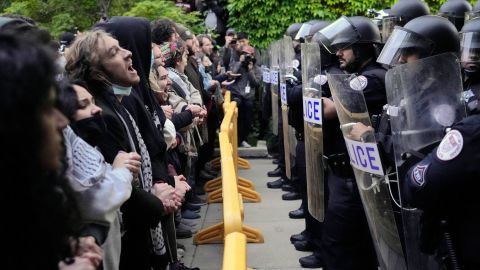 Pro-Palestinian protesters chant at University of Chicago police while being kept from the university's quad as the student encampment is dismantled Tuesday, May 7, 2024, in Chicago. (AP Photo/Charles Rex Arbogast)
