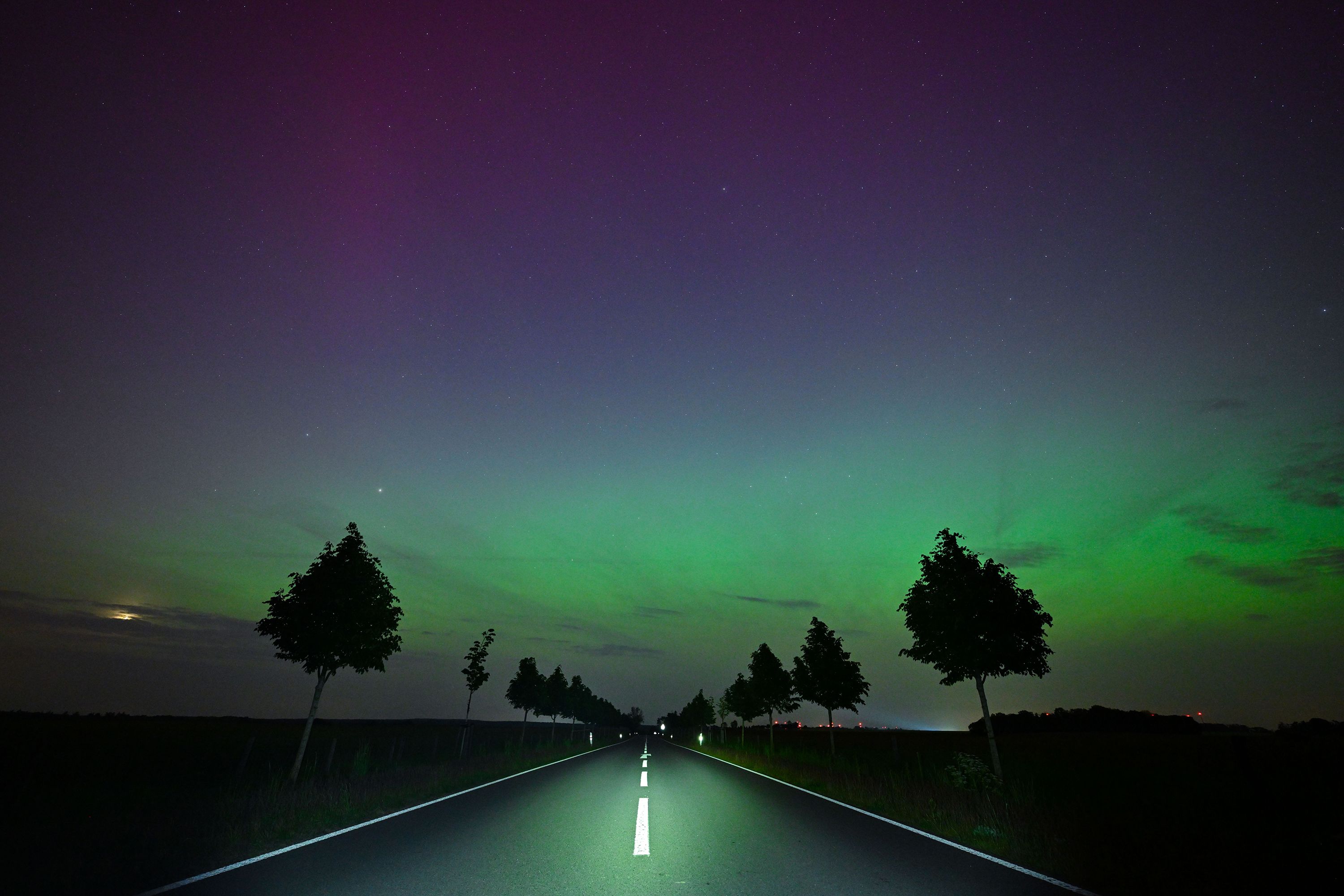 The northern lights glow in the night sky in Brandenburg، Germany، on May 10.