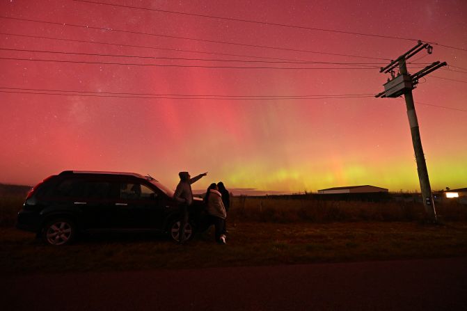 People look at the aurora australis on the outskirts of Christchurch, New Zealand, on May 11.