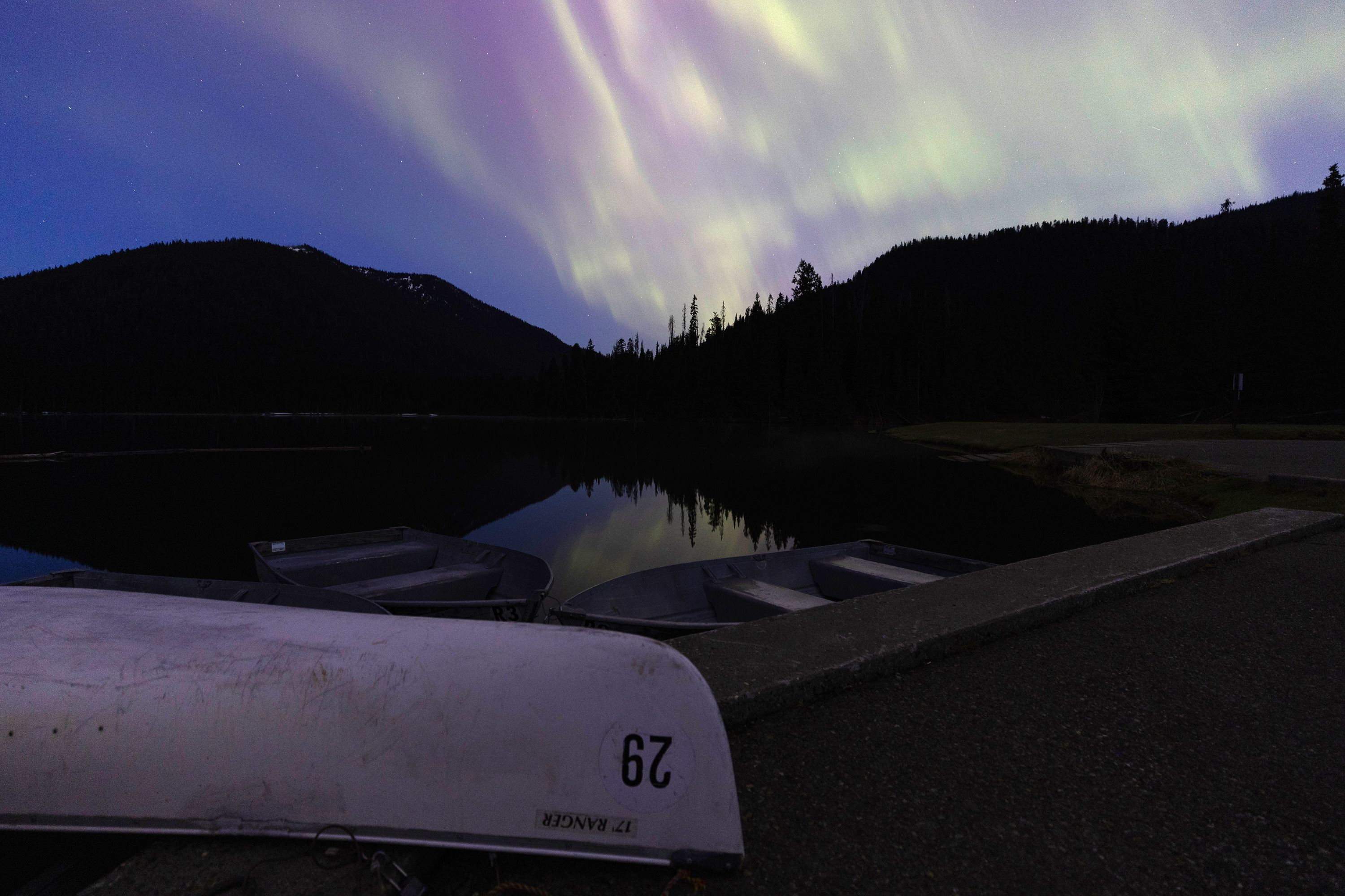 Aurora borealis is reflected in water at Manning Park in British Columbia، on May 11.