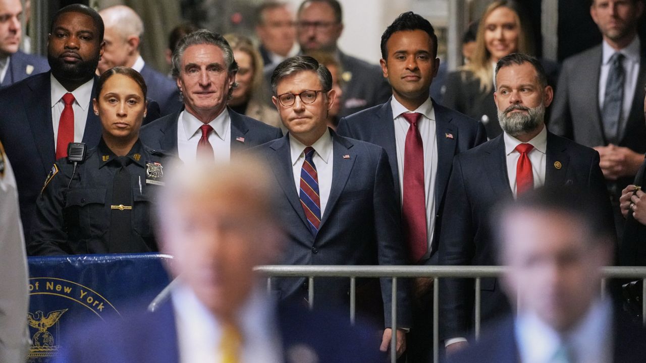 US Representative Byron Donalds, Republican of Florida, Governor of North Dakota Doug Burgum, US Speaker of the House Mike Johnson, former presidential candidate Vivek Ramaswamy and US Representative Cory Mills, Republican of Florida, listen as former President Donald Trump speaks to reporters as he arrives to attend his trial for allegedly covering up hush money payments linked to extramarital affairs, at Manhattan Criminal Court in New York City, on May 14, 2024.