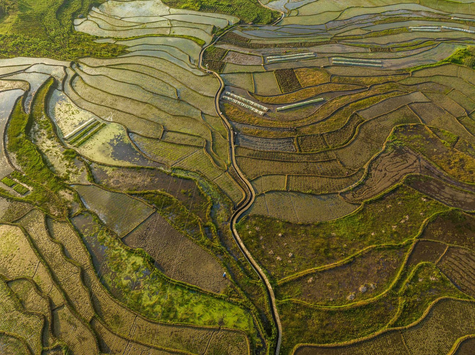 Villagers work in a terraced field in Shiyuan, a village in Bijie, China, on Monday, May 13.
