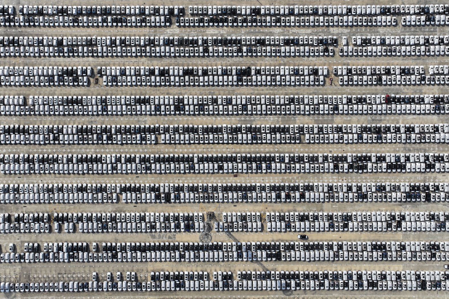 This aerial photo, taken on Monday, May 13, shows new cars waiting to be transported from a port in Nanjing, China.