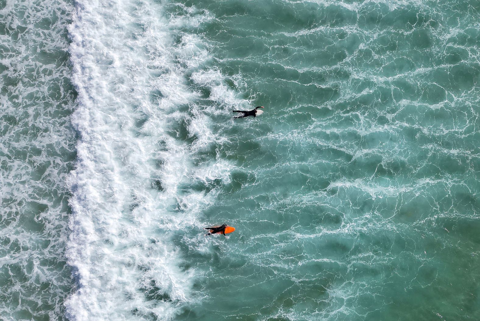 This photo, taken with a drone, shows surfers at Fistral Beach in Newquay, England, on Thursday, May 9.