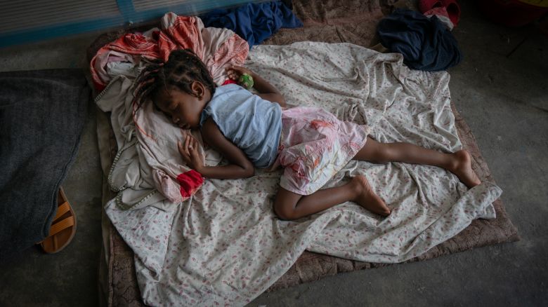 PORT AU PRINCE, HAITI. MAY 6. Inside the Lycee Marie Jeanne High School, a young displaced girl sleeps on the floor of a corridor. Some 1800 people are estimated to be crammed into the former girls' school.