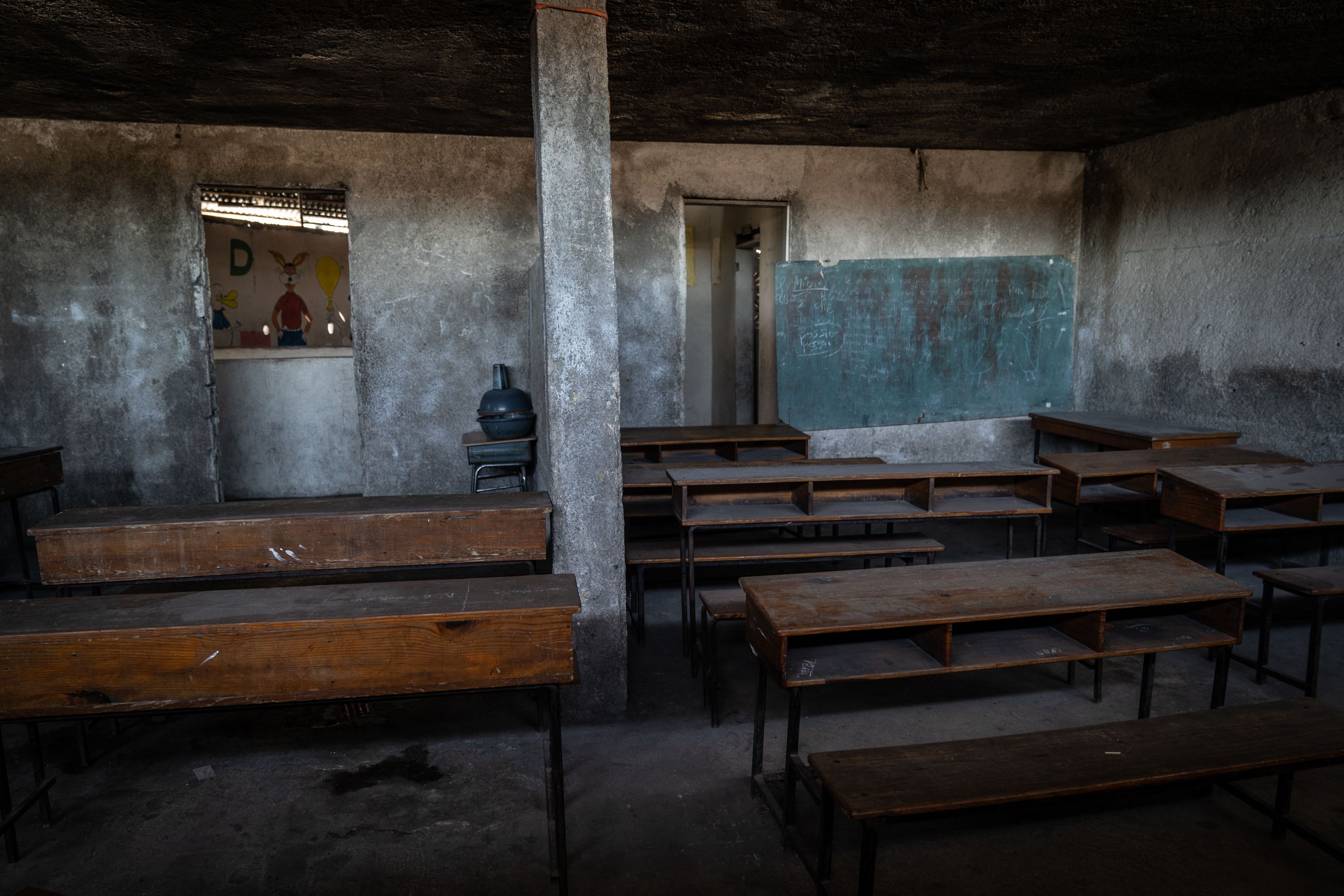 Empty desks are seen inside a former Port-au-Prince school that was abandoned in late February because of gang violence.