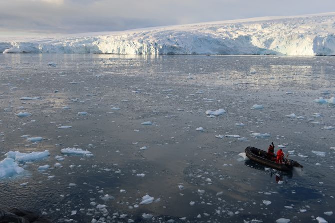 A Zodiac small boat travels races away from an island drop off near Palmer Station, on Anvers Island, Antarctica. The US's Palmer Station focuses on marine science, and small boats are used frequently for travel. (Approx Feb 2018)
