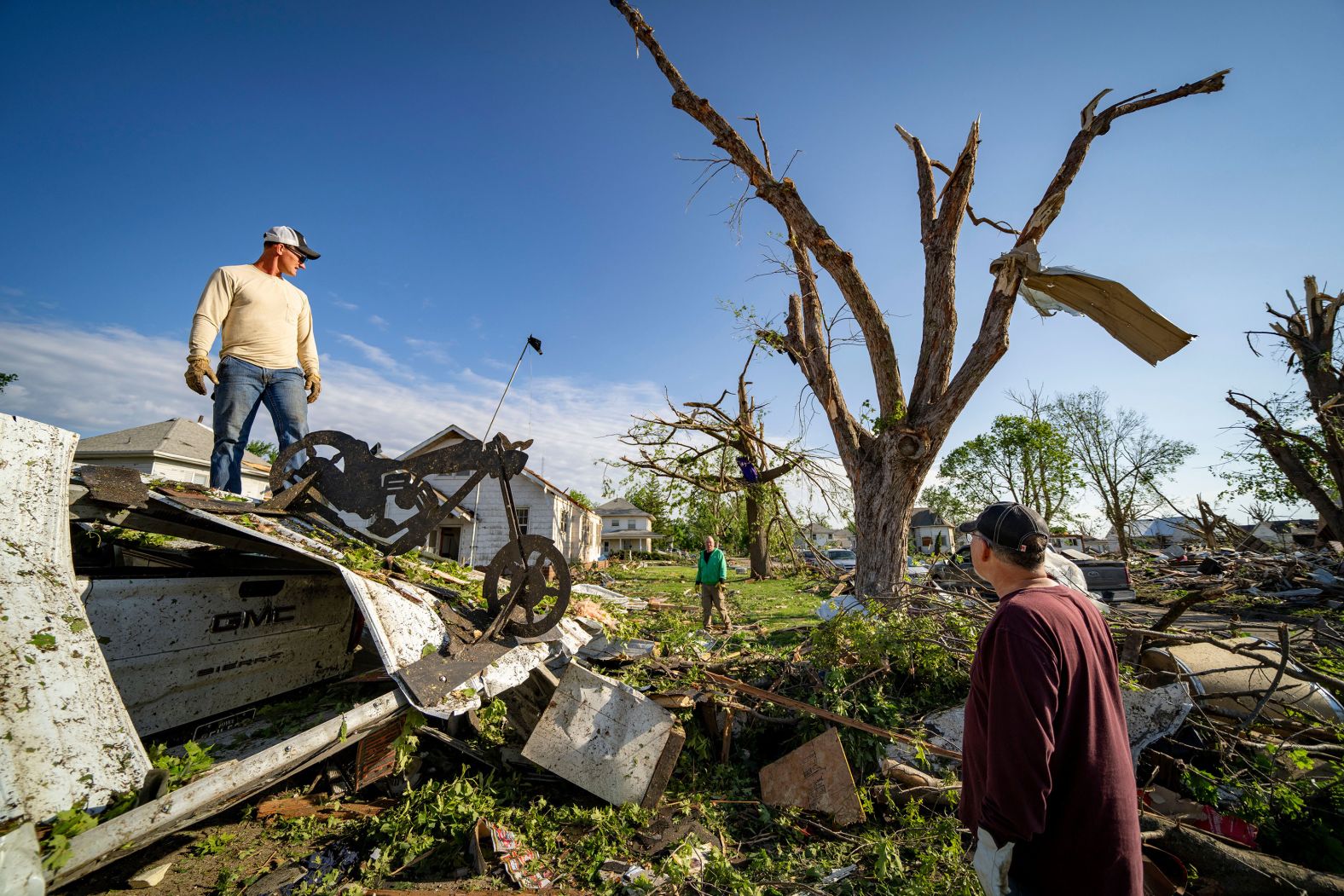 Friends and family help Randy Hennigar clean up debris from outside his home in Greenfield, Iowa, on Wednesday, May 22. <a href="index.php?page=&url=https%3A%2F%2Fwww.cnn.com%2F2024%2F05%2F22%2Fweather%2Fiowa-tornado-damage-storm-forecast-wednesday%2Findex.html" target="_blank">A tornado ravaged Greenfield on Tuesday</a>, leaving four dead and at least 35 injured, the Iowa State Patrol said on Wednesday night.