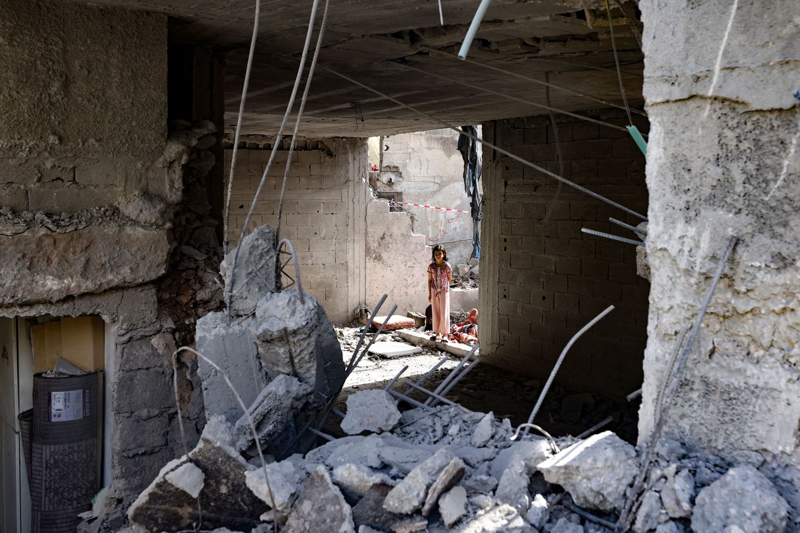 A Palestinian child stares at the rubble of a building in Jenin, West Bank, on Saturday, May 18. The Israel Defense Forces said <a href="index.php?page=&url=https%3A%2F%2Fwww.cnn.com%2Fmiddleeast%2Flive-news%2Fisrael-hamas-war-gaza-news-05-17-24%2Fh_6fd05d869896b3d7d5b7f29eff48d6ab" target="_blank">they carried out an airstrike on "an operations center" in Jenin</a> on Friday and killed "a significant wanted" militant. Al Quds Brigade, the military wing of Islamic Jihad, confirmed the killing of Islam Khamaysa in a statement, saying he was a leader of the Jenin Brigade.