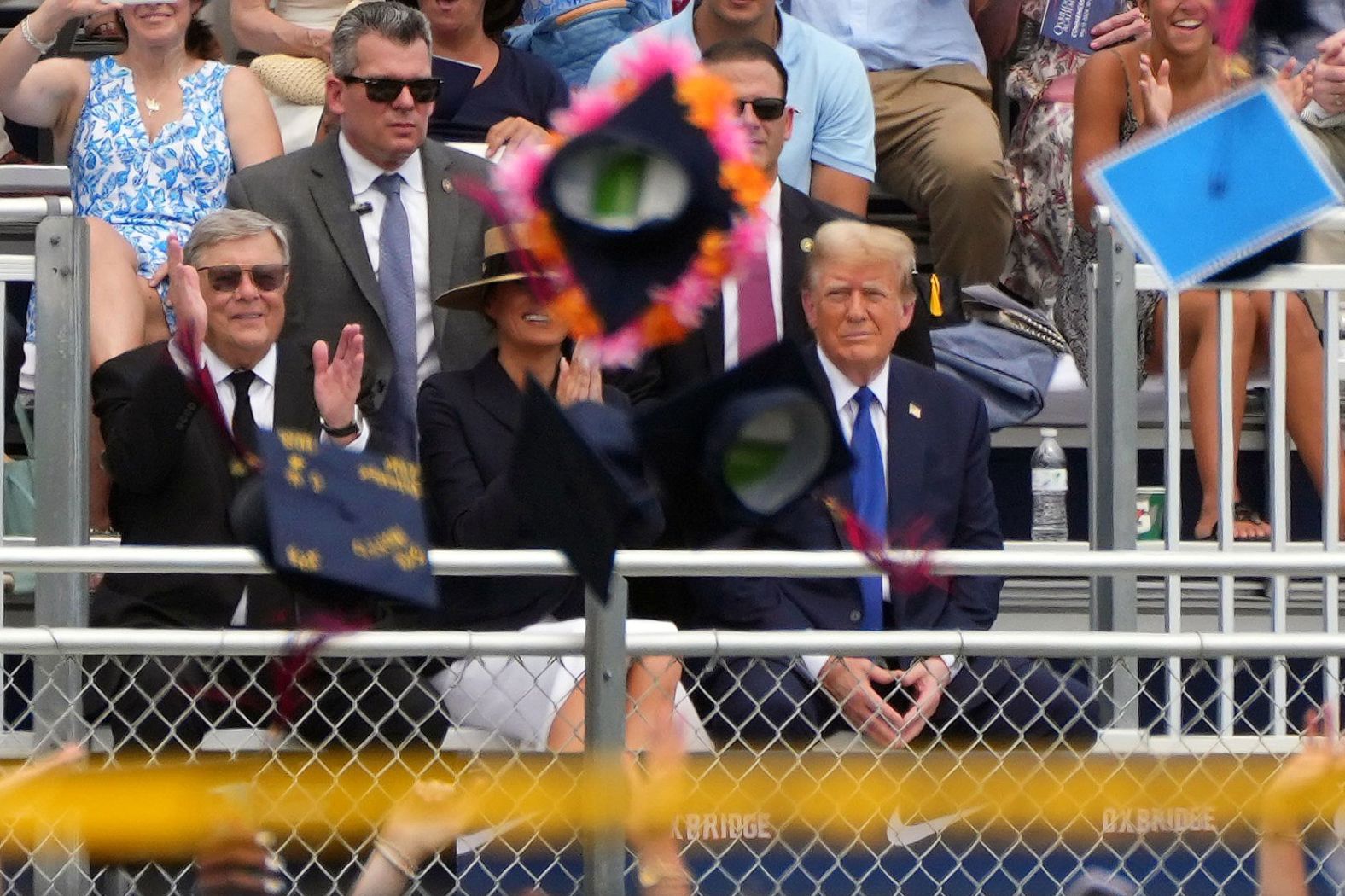 Graduation caps fly as former US President Donald Trump and former first lady Melania Trump attend the high school graduation ceremony of their son, Barron, in West Palm Beach, Florida, on Friday, May 17.