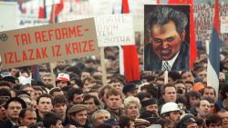 A demonstrator holds a portrait of Serbian Communist Party leader Slobodan Milosevic in Belgrade as thousands of people head for a Serbian nationalist rally on 19th November 1988, only hours after ethnic Albanians took to the streets in Serbian's autonomous province of Kosovo to protest Serbian repression. Milosevic was campaigning to abolish the autonomous status of Kosovo. (Photo credit should read PATRICK HERTZOG/AFP via Getty Images)