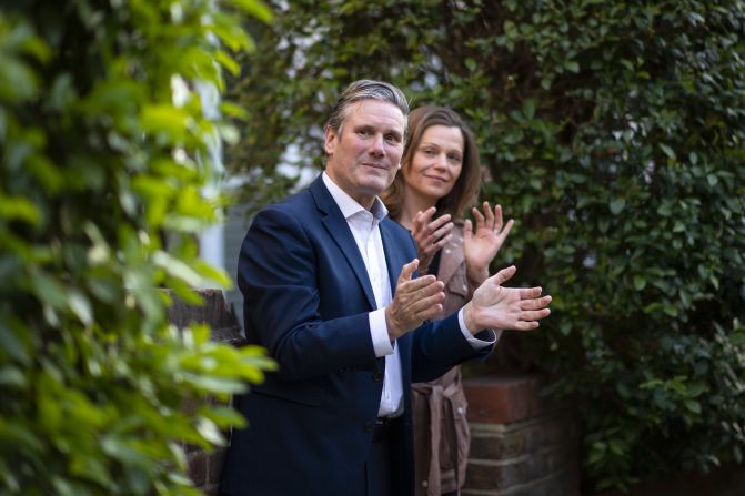Starmer and his wife, Victoria, applaud essential workers outside their home in London in May 2020. This was during the first few months of the Covid-19 pandemic.
