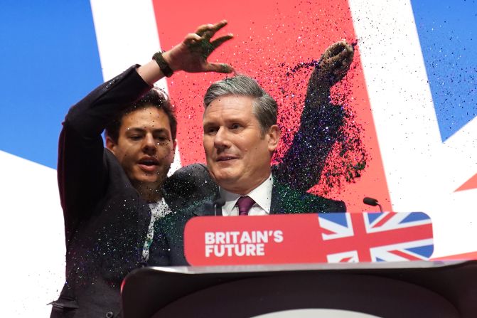 A protester throws glitter over Starmer, disrupting his keynote speech at the Labour Party Conference in Liverpool in October 2023.