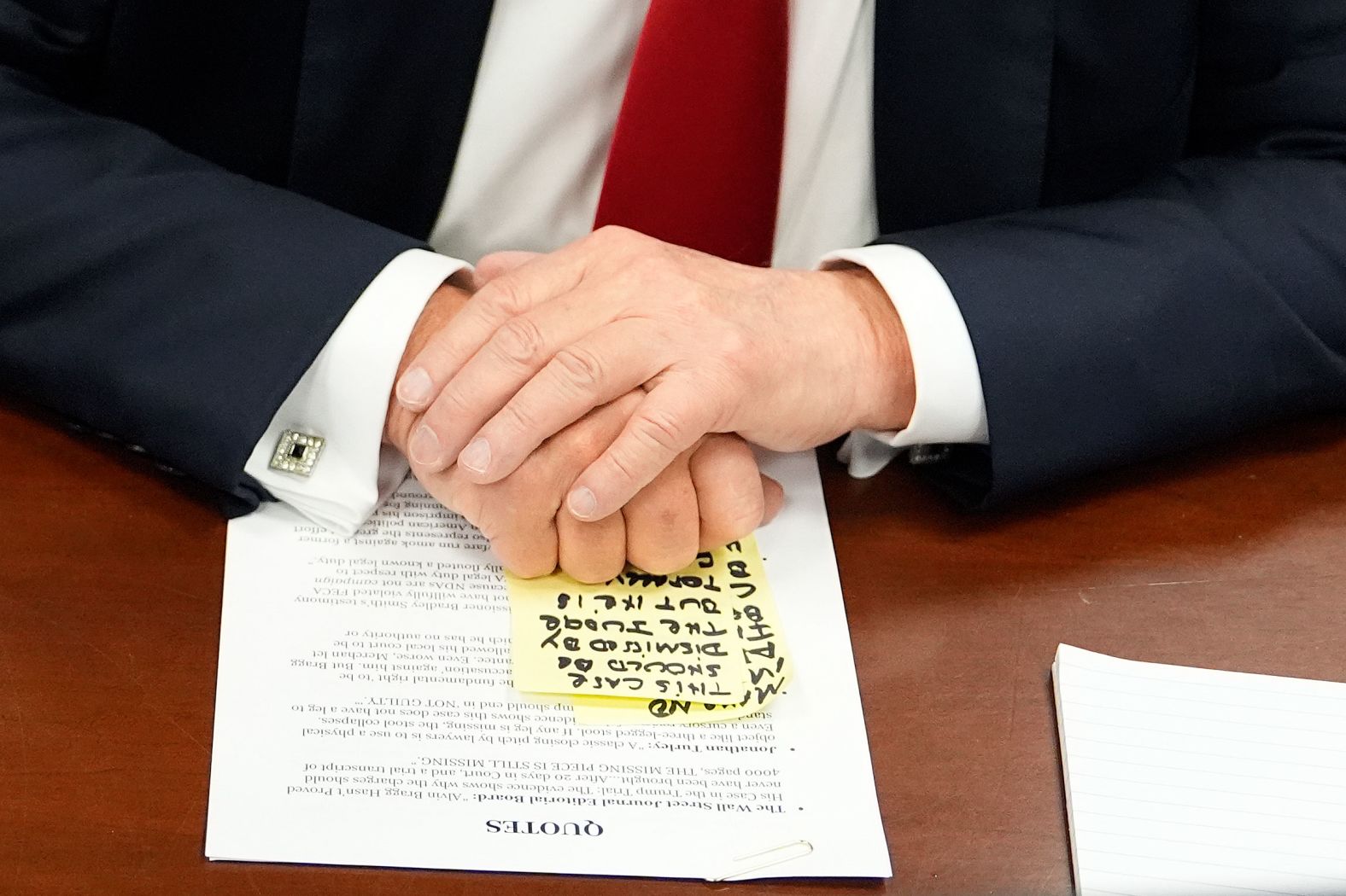 Notes are seen under the hands of former US President Donald Trump as he awaits the start of court proceedings in his hush money trial on Tuesday, May 28.