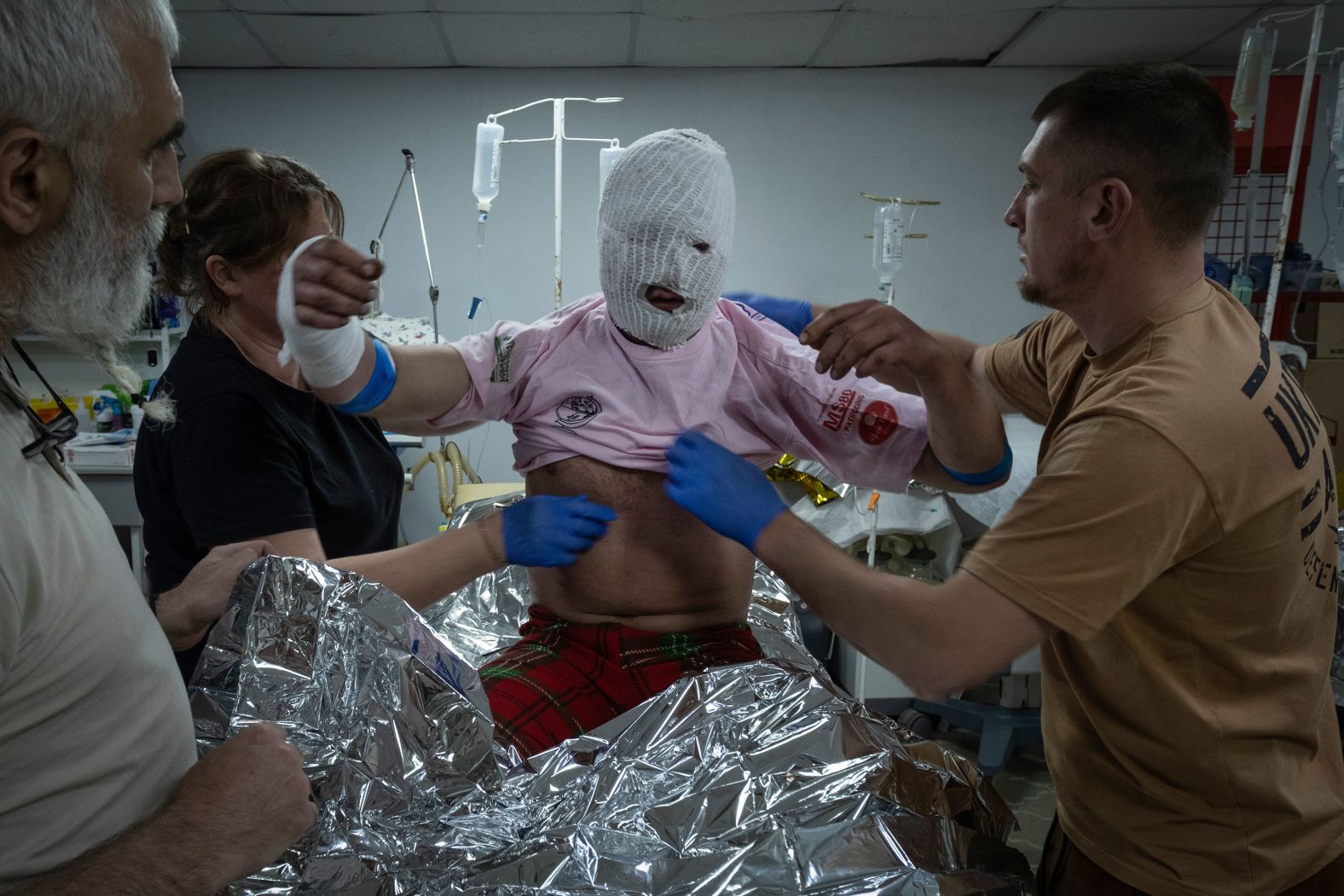 Military medics give first aid to a wounded Ukrainian soldier near Bakhmut, Ukraine, on Friday, May 24.