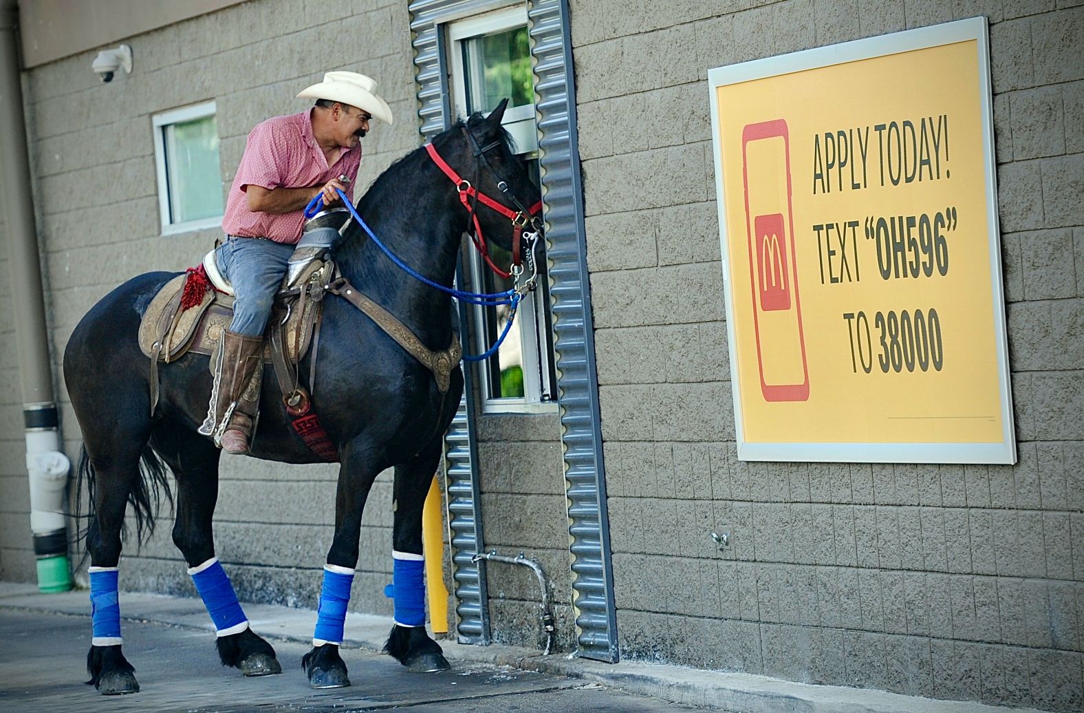 Ramón Martinez Prieto and his horse Nikki goes through a McDonald's drive-through to pick up lunch in Enon, Ohio, on Saturday, May 25.
