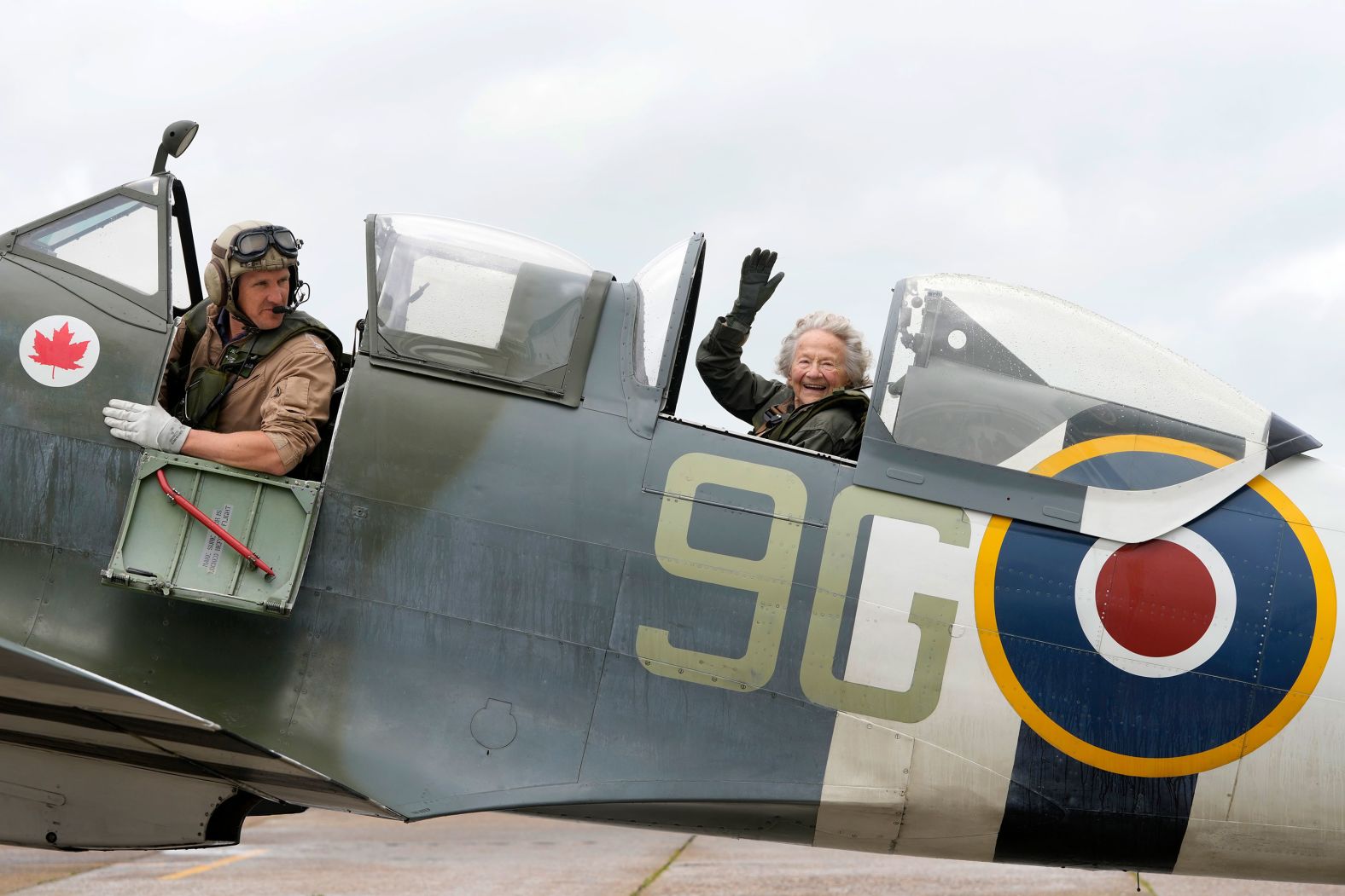 Dorothea Barron, a 99-year-old World War II veteran, sits in a Spitfire with pilot Jeremy Britcher in Kent, England, on Tuesday, May 28. The Taxi Charity for Military Veterans took World War II veterans to an event at the Biggin Hill Heritage Hangar just ahead of their trip to Normandy, France, for the 80th anniversary of D-Day.