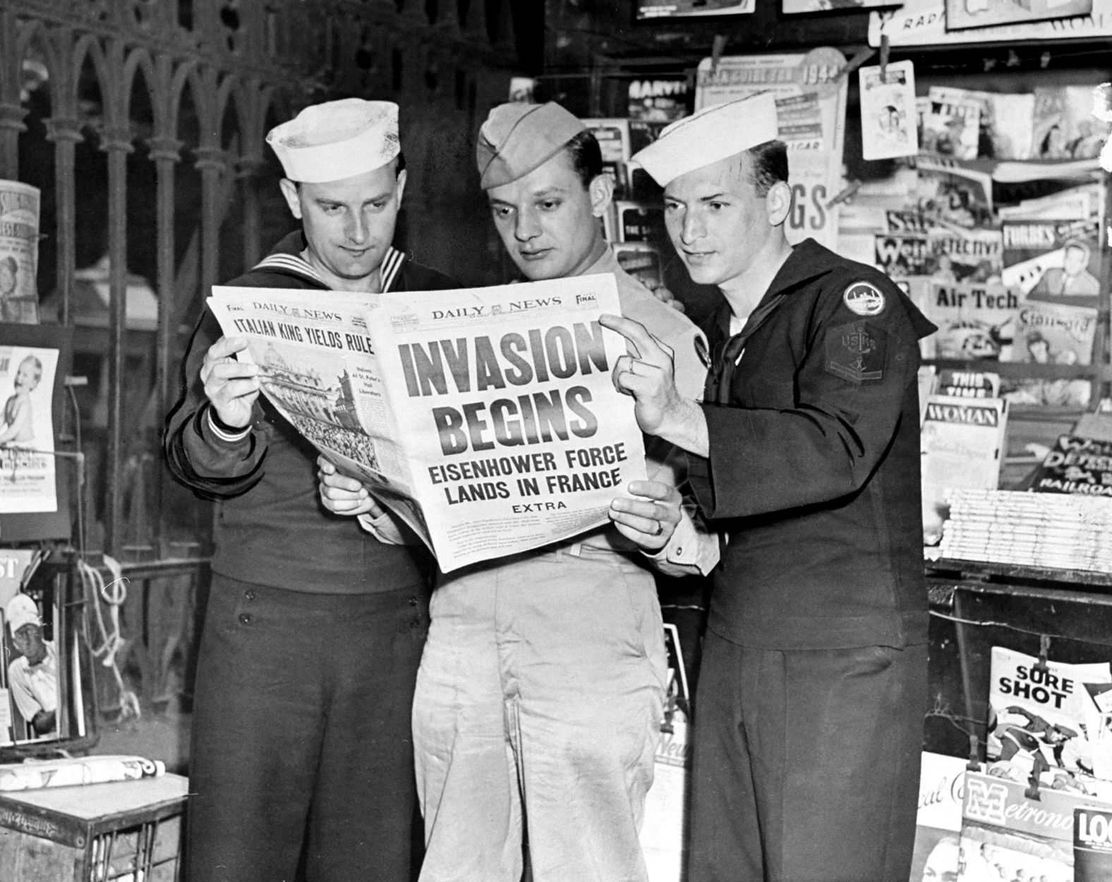 US servicemen in New York read news about the D-Day invasion. The operation was led by Gen. Dwight D. Eisenhower, who would later become president of the United States.