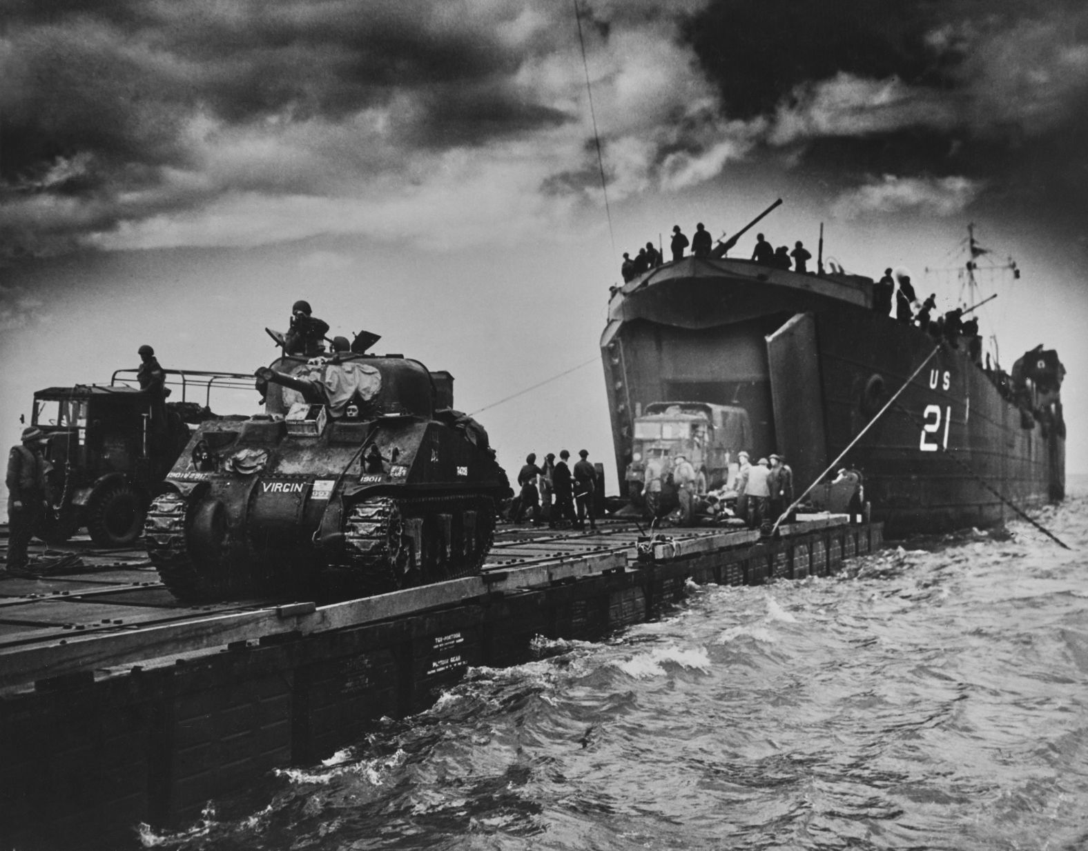 British tanks are seen on an American landing barge crossing the English Channel.