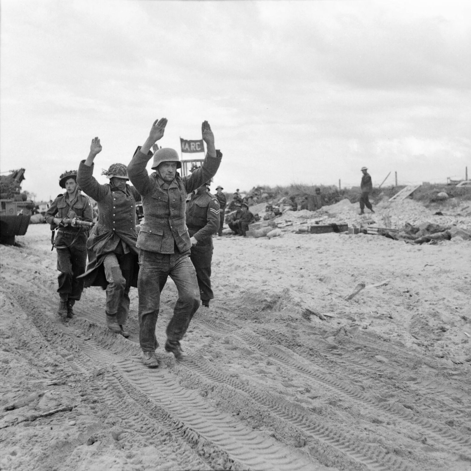 British troops escort German prisoners in Normandy.
