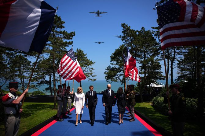 From left, French first lady Brigitte Macron, French President Emmanuel Macron, US President Joe Biden and US first lady Jill Biden arrive for a D-Day ceremony at the Normandy American Cemetery and Memorial in Colleville-sur-Mer, France, on Thursday.