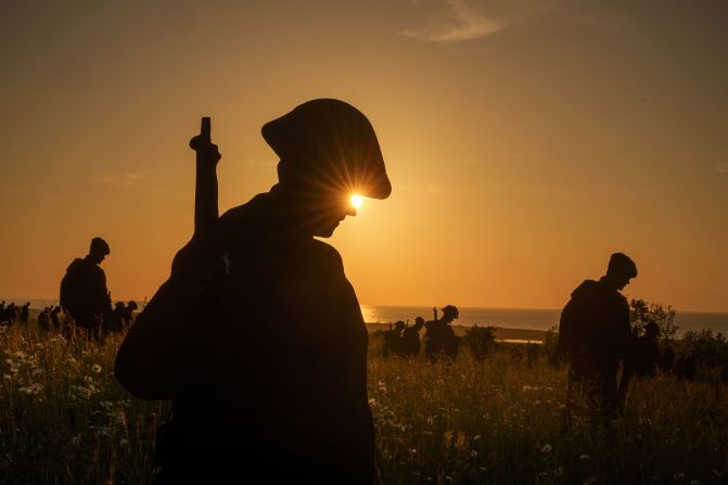 The sun sets behind the "Standing with Giants" installation at the Normandy British Memorial in Ver-sur-Mer, France, on Sunday, June 2. The D-Day anniversary was June 6.