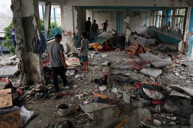 People in Nuseirat, Gaza, look inside a United Nations-run school that was struck by an <a href="https://www.cnn.com/2024/06/06/middleeast/israel-airstrike-un-school-gaza-intl-hnk/index.html" target="_blank">overnight Israeli airstrike</a> on Thursday, June 6. At least 40 people were killed in the strike, according to medical workers at the nearby Al-Aqsa Martyrs Hospital. The school, run by the UN agency for Palestinian refugees, was housing displaced people in the Nuseirat refugee camp at the time of the incident, the Gaza government media office said. The Israeli military confirmed it carried out the airstrike, which it said targeted a Hamas compound operating inside the school. Israeli military spokesperson Lt. Col. Peter Lerner later told journalists the military was not "aware of any civilian casualties."