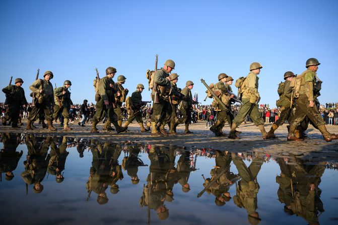 People wear replica military attire as part of D-Day commemorations in Normandy, France, on Thursday.