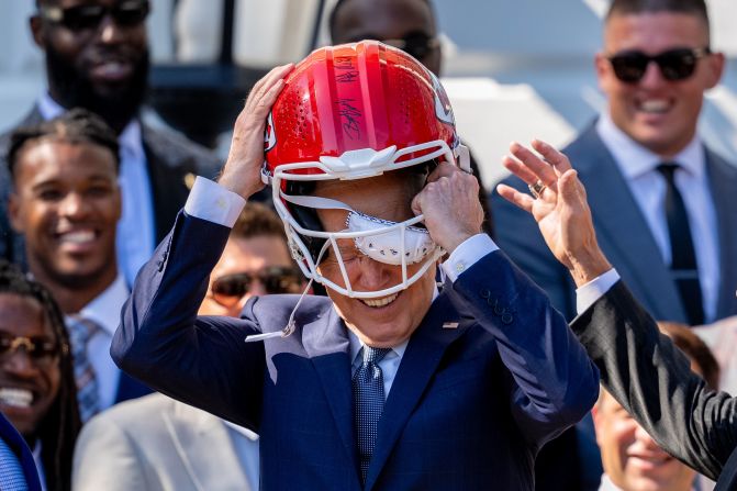 Biden puts on a Kansas City Chiefs football helmet as he welcomes the Super Bowl champions to the White House on Friday, May 31.