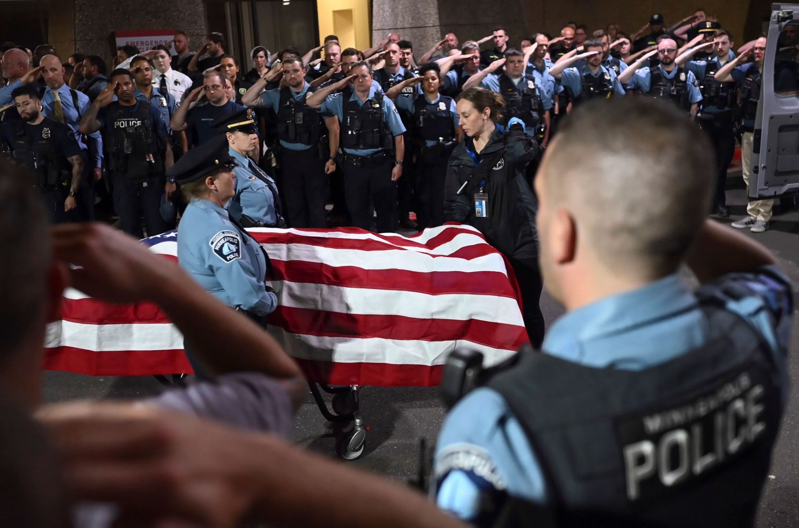 Law enforcement officers salute the flag-draped remains of Minneapolis police officer Jamal Mitchell on Thursday, May 30. Mitchell, 36, <a href="index.php?page=&url=https%3A%2F%2Fwww.cnn.com%2F2024%2F05%2F30%2Fus%2Fminneapolis-incident-officers-injured%2Findex.html" target="_blank">was killed by a gunman who ambushed him</a> as he responded to the scene of another shooting, police said.
