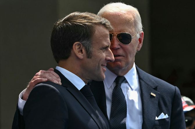 French President Emmanuel Macron, left, and US President Joe Biden attend the ceremony in Colleville-sur-Mer.