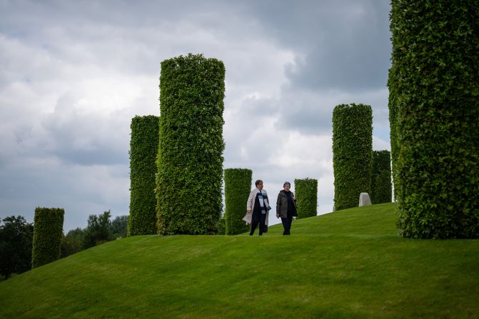 People walk in the gardens at the National Memorial Arboretum in Alrewas, England.