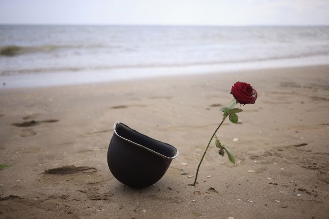 This military helmet and rose were left behind by well-wishers on Utah Beach.