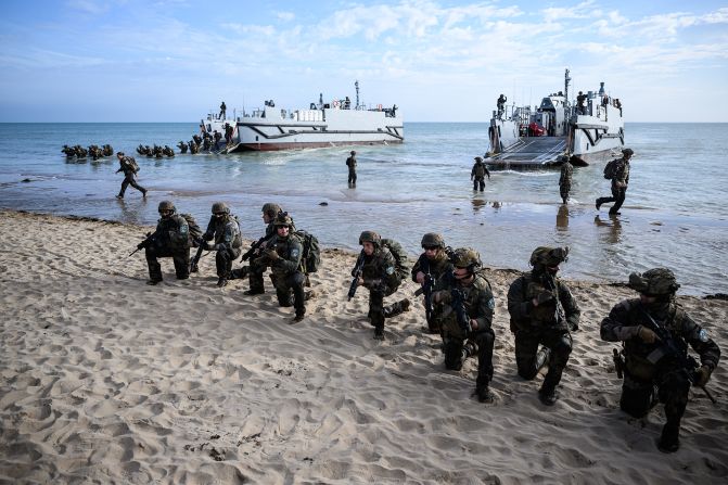 French troops disembark from a US landing craft during an amphibious landing showcase at Omaha Beach on Tuesday.