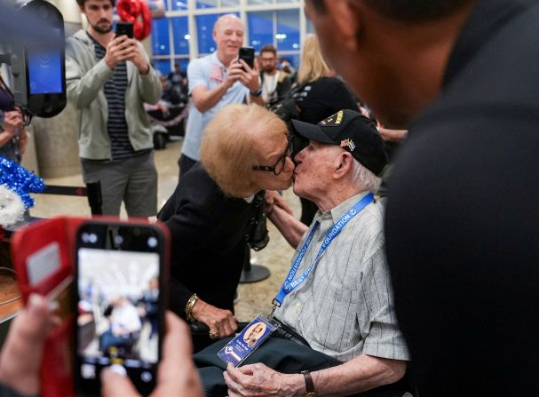 Betty Ann Margol gives a goodbye kiss to her husband, Hilbert, before he boarded a plane in Atlanta on Sunday, June 2. He was traveling with a group of veterans to Normandy to commemorate D-Day.