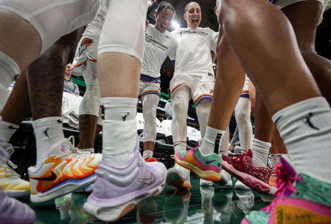 Members of the WNBA's Phoenix Mercury huddle before a game in Seattle on Tuesday, June 4.